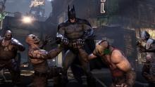 Batman breaking the hands of some thugs in Batman: Arkham City