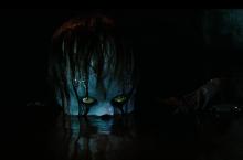 Pennywise looks out from the water.